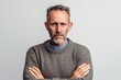 © Leon Waltz - Lifestyle portrait photography of a man in his 40s looking anxious and fidgety due to generalized anxiety disorder wearing a cozy sweater against a white background