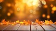 © NK - Wooden table with orange autumn leaves at sunset in defocused