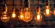 © MstAsma - Decorative antique edison style light bulbs against brick wall background. vintage lamp decorative.