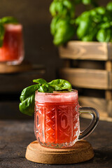 Wall Mural - watermelon drink with basil on a dark background