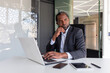 © Liubomir - Thinking mature adult african american businessman at workplace, financier boss investor with laptop thinking about financial solutions new projects inside office.