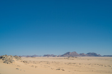 Canvas Print - view in the Sahara desert of Tadrart rouge tassili najer in Djanet City  ,Algeria.colorful orange sand, rocky mountains