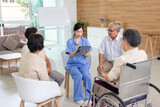 Nursing Home Care concept. Friendly nurse caregiver supporting an eldery.