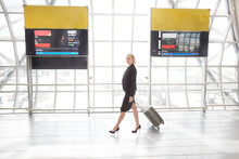 Businesswoman With Luggage At Suvarnabhumi Airport In Bangkok