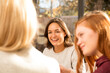 © Connect Images - Smiling young woman talking with friends