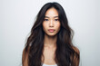 © Julia Jones - Photo of a pretty Asian girl with perfect skin and long hair on a white background