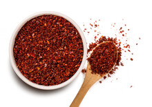 A Pile Of Red Pepper Flake Or Heap Of Red Pepper Powder Coarse. Korean Chili Ground Gochugaru In White Bowl Isolated On Transparent Background. Top View, Flat Lay, Overhead