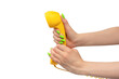 © Nikolay - Yellow handset in woman hand with green nails isolated on a white background.