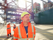 © Connect Images - Portrait of dock worker in reflective clothing looking away, Felixstowe, England.