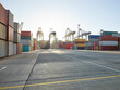 © Connect Images - Cargo cranes and shipping containers stacked up on concrete in dockyard, Felixstowe, England