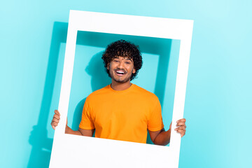 Photo of cheerful nice young person toothy smile hands hold paper album set card moment isolated on bright teal color background