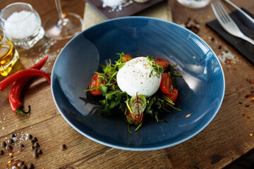 Wall Mural - Burrata with paprika-truffle jam and cherry-cluster tomato salad. Delicious healthy Italian traditional food closeup served for lunch in modern gourmet cuisine restaurant