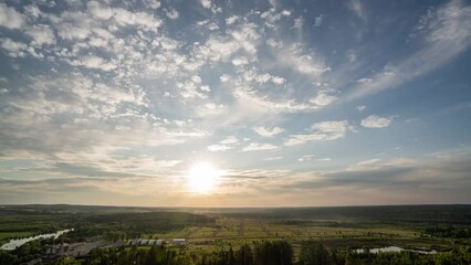 Wall Mural - timelapse of sunset over vallecas city with few clouds in the sky and orange teal tones.