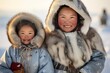 inuit women and children posing outside in the snow