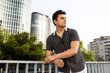 © ADDICTIVE STOCK - Thoughtful man looking away and leaning on railing in city