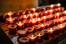 Rows Of Burning Votive Candles In A Dark European Catholic Church In Rome Italy Seeking Favor From The Lord Or Saint