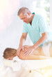 © JackF - Male massage therapist working out back zone of female patient during deep tissue back massage