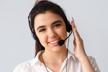 Wall Mural - Female technical support agent on  light background