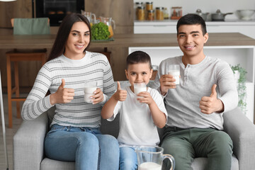 Poster - Happy family with glasses of milk showing thumbs-up at home