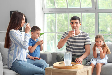 Sticker - Happy parents with their little children drinking milk at home