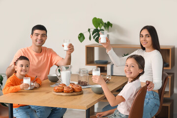 Sticker - Happy family drinking milk at breakfast in kitchen