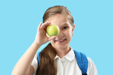 Sticker - Little schoolgirl with apple on light blue background