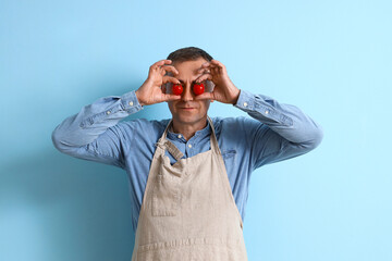 Sticker - Mature man with fresh tomatoes on blue background