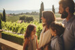© Justlight - A family of four standing in the grounds of the villa smiling as they look out to the vineyards beyond.