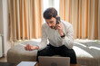 © Miljan Živković - One man adult Caucasian male work from hotel room make a phone call