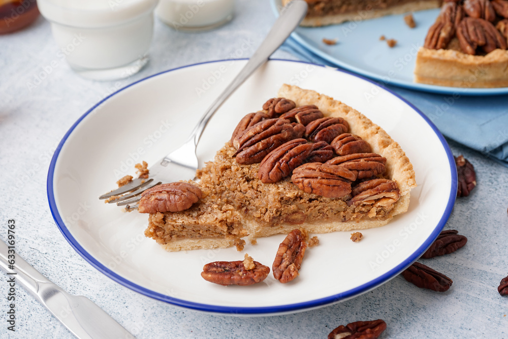 Plate with piece of tasty pecan pie on grey background