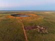 Aerial view of Wolfe Creek Meteorite Crater in the remote Kimberley region of Western Australia. Camp ground in the foreground.
