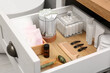 Open cabinet drawer with tampons and feminine hygiene products