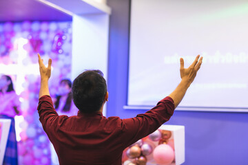 Wall Mural - Singing together, raising hands to worship Jesus in the church