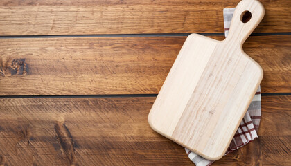 Wall Mural - Cutting board over towel on wooden kitchen table. Top view