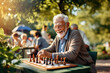 © Kalim - AI generated image of senior playing chess in the park