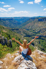 Wall Mural - Woman on peak enjoying mountain landscape- France, Herault