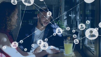 Poster - Animation of network of profile icons over diverse man and woman discussing in cafe at office
