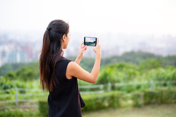 Sticker - Woman use of cellphone to take phone on mountain