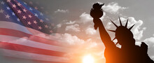 Statue Of Liberty Silhouette And USA Flag On Sunset Background. American Holiday Concept. 3d Illustration