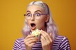 Portrait of a surprised young girl with bright makeup, isolated on purple background, eating popcorn. Generative AI