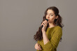 © ako-photography - attractive teenager woman speaking with a microphone against gray background, conference speaker