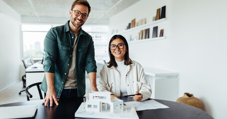 Poster - Young architects working on a house project in an office