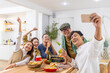 © CandyRetriever  - Group of Cheerful Asian man and woman using mobile phone taking selfie together during celebration dinner party at home. Happy people friends enjoy and fun reunion meeting holiday event on vacation.