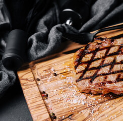 Wall Mural - Grilled striploin sliced steak on cutting board over stone table