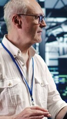 Poster - vertical video trained engineer expertly managing data while navigating in industrial server room. s