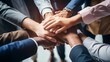 © Rzk - Business team putting their hands together, unity and teamwork concept, top view