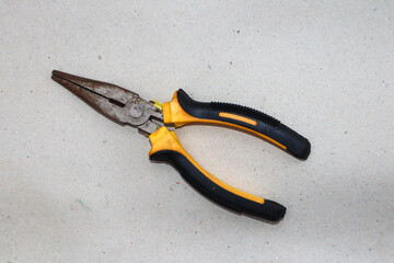 Yellow pliers and black pliers on a white background,close up photo.