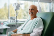 © wolfhound911 - Bald mature man smiling in cancer hospital bed .