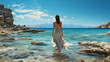 © wolfhound911 - Greek goddess standing majestically against the backdrop of a blue sea and a blue sky.