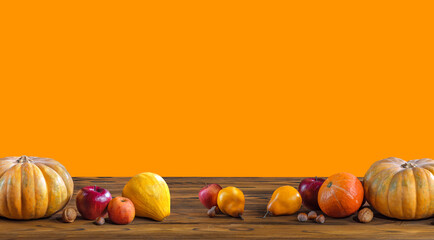 Wall Mural - Thanksgiving day pumpkin harvest on a orange isolated background. Squash, orange vegetable autumn fruit, apples, and nuts on a wooden table for traditional Halloween decoration fall design